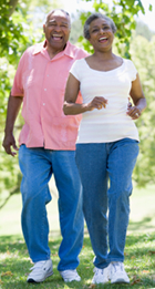 Senior African American couple walk briskly